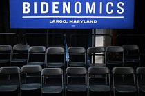 Chairs sitting in rows with a Bidenomics sign above them