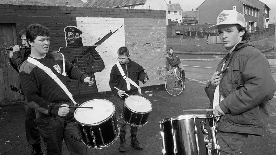A black and white photo of boys playing drums in Belfast in 1991