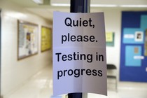 A sign asking people to be quiet while testing takes place