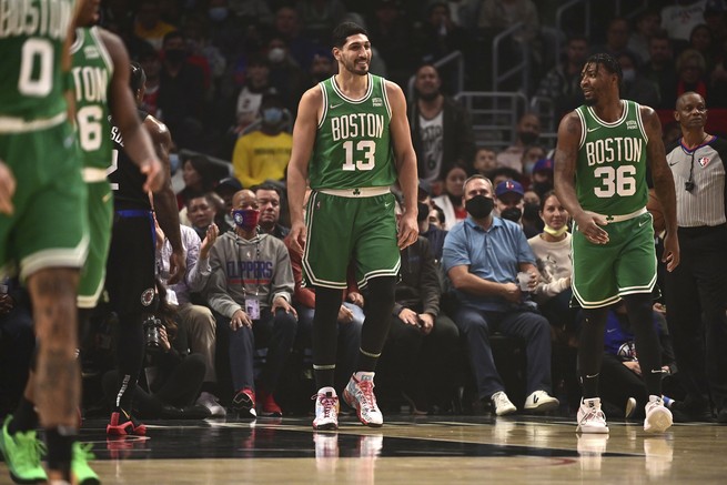 Boston basketball players on the court with Freedom in the middle