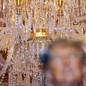 Picture of chandelier behind blurred face of Donald Trump