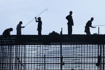 Silhouetted construction workers