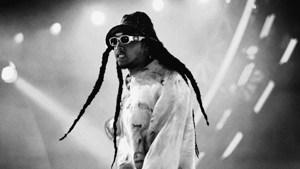 Black and white photo of Takeoff from Migos