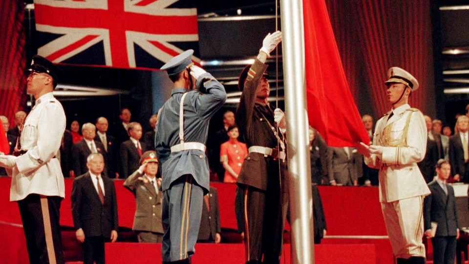 The Chinese flag is raised by People's Liberation Army soldiers to signal Hong Kong's return to Chinese sovereignty after 156 years of British rule in Hong Kong on July 1, 1997. 