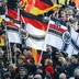 Supporters of the anti-immigration right-wing movement Patriotic Europeans Against the Islamization of the West carry various versions of the Imperial War Flag during a protest.
