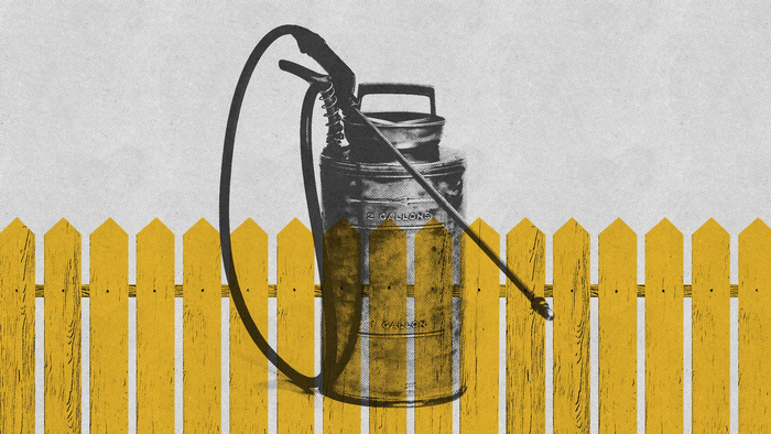 a pesticide container behind a fence