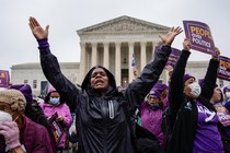 An activist raises her arms in celebration