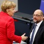 Chancellor Angela Merkel speaks with Martin Schulz.
