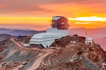 a photo of the Vera Rubin Observatory with a colorful sky