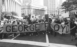 photo of protesters with 'George Floyd' banner