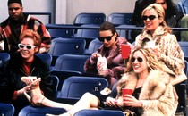 Carrie, Samantha, Miranda, and Charlotte wear sunglasses and watch a baseball game