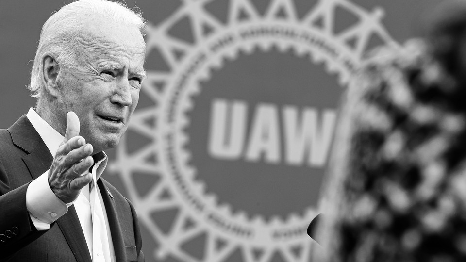 A photo of Joe Biden in front of a UAW sign