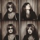 A series of black-and-white images of a woman, sometimes wearing sunglasses, taken in a photo booth