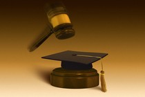 A gavel hitting a graduation cap