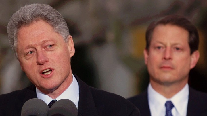 Bill Clinton speaking with Al Gore in the background