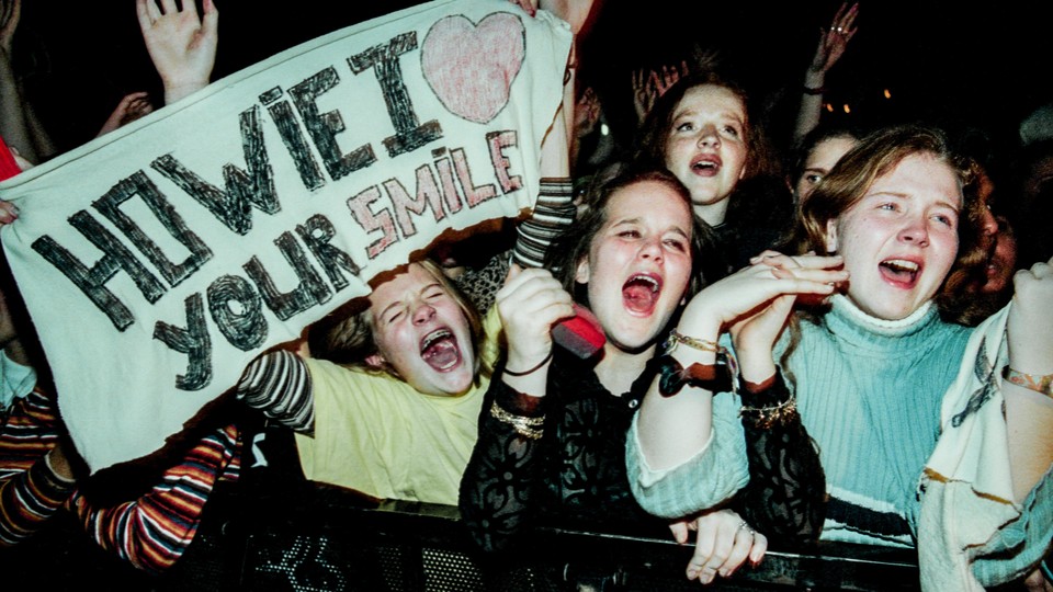 Photo of young fans screaming for the Backstreet Boys at a show in 1996