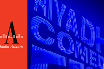 An illuminated neon blue sign reads "Riyadh Comedy Festival"