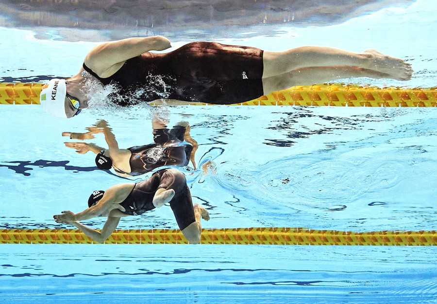 Two swimmers are seen underwater during a race.