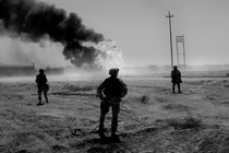 An image of U.S. soldiers standing guard over an Iraqi oilfield, 2003