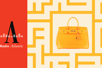 A yellow Birkin bag against a yellow background