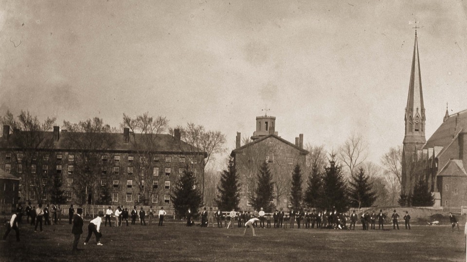People stand on Wesleyan's college quad, near the campus's gothic Memorial Chapel.