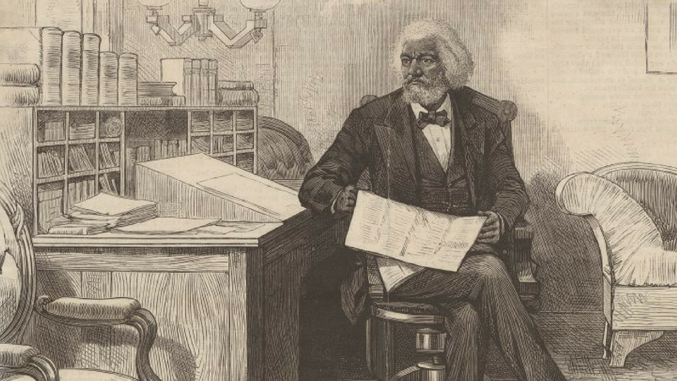 An illustration of Frederick Douglass sitting with a writing box atop his desk