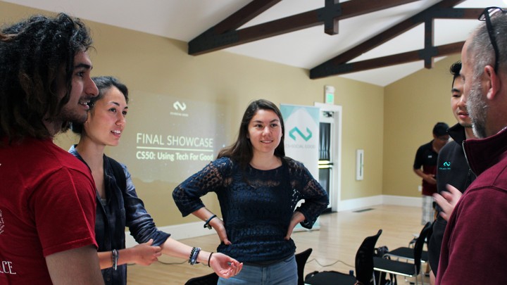 Students and faculty are pictured in conversation.