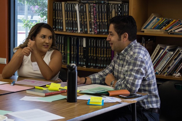 A new teacher at PUC who's part of the Alumni Teach Project works with her mentor.