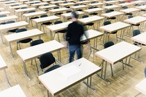 A man walks out of an empty classroom