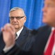 Former Maricopa County Sheriff Joe Arpaio looks on as then-presidential candidate Donald Trump speaks to reporters.