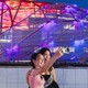 Two women take a selfie in front of the Intuit Dome.