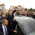 French presidential election candidate Emmanuel Macron greets supporters as he leaves a polling station on May 7, 2017.