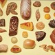 photo of many different types of breads on yellow background