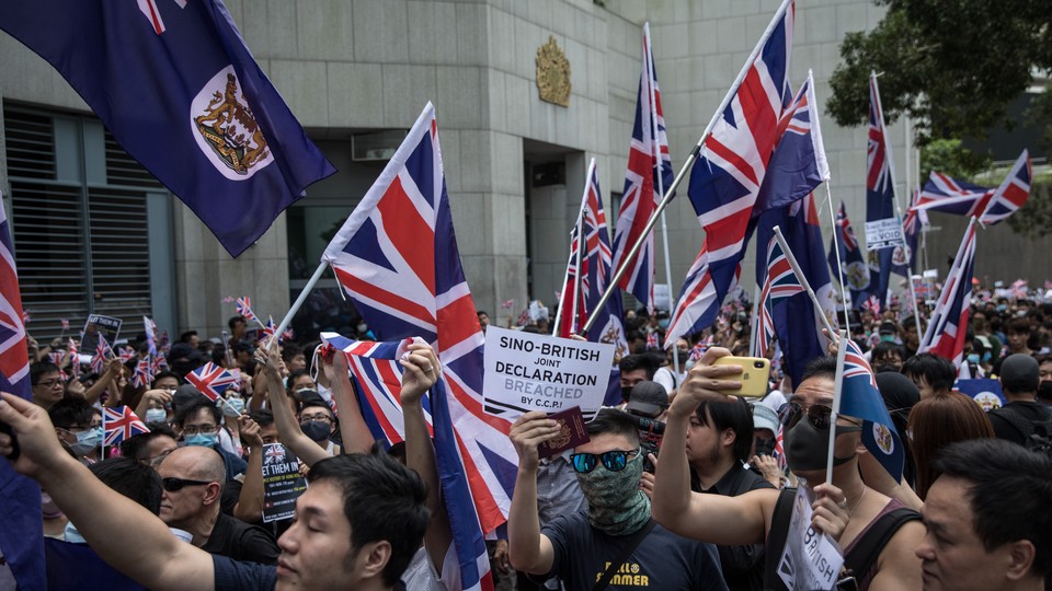 Pro-democracy protesters wave flags outside of the UK Embassy in Hong Kong in September 2019.