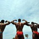 Men flex during a bodybuilding event in California.