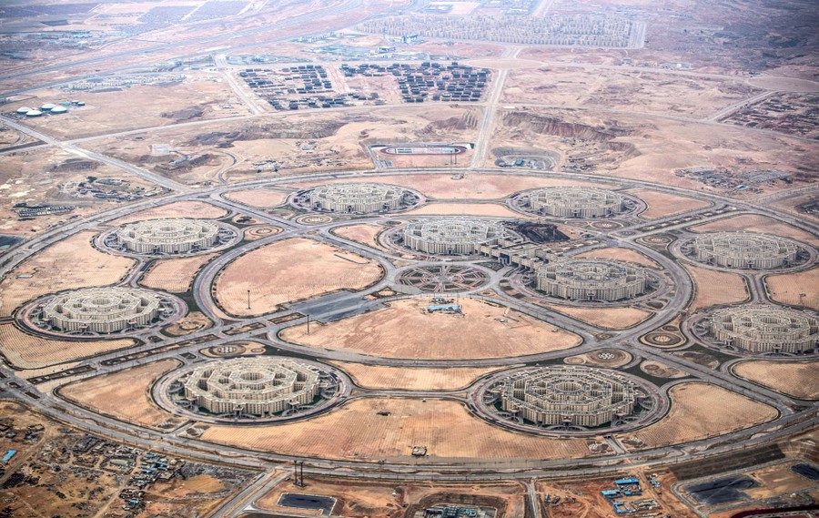 An aerial view of an office-building complex under construction, made up of 10 octagonal buildings arranged within circular roads