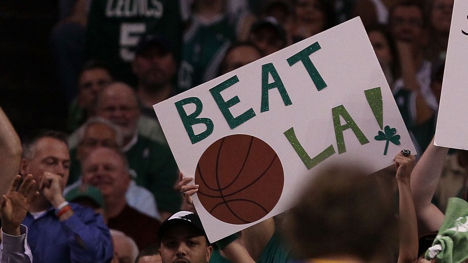 Fans of the Boston Celtics hold a 'Beat L.A.!' sign