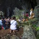 Family members pray before a shrine in Tham Luang cave area as operations were underway for the 12 boys and their coach.