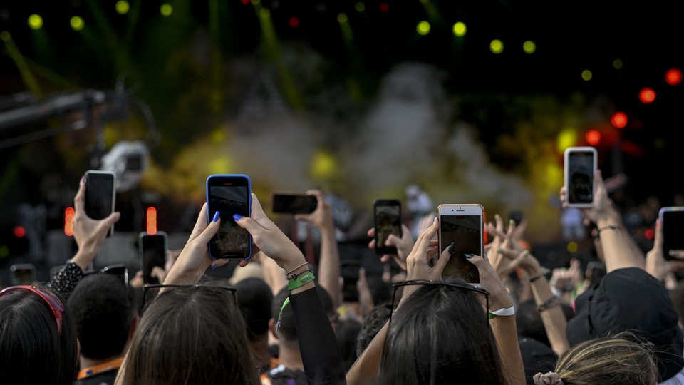 Fans on their phones at the Rock in Rio music festival in Rio de Janeiro, Brazil, on September 3, 2022