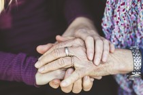 Two hands holding each other