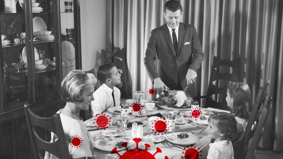 A black-and-white photo of a family sitting down for a holiday dinner, overlaid with red coronavirus particles