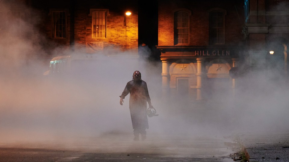 Mark Burnham as Leatherface walking through a misty street in Netflix's "Texas Chainsaw Massacre"