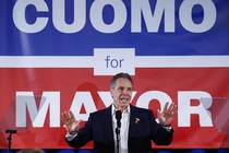 Andrew Cuomo in front of a giant "Cuomo for Mayor" sign