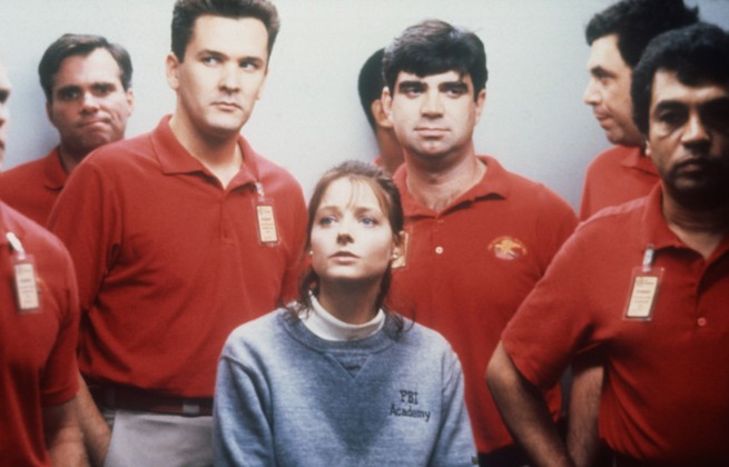Clarice Starling played by Jodie Foster in Silence of the Lambs surrounded by other male officers during FBI training