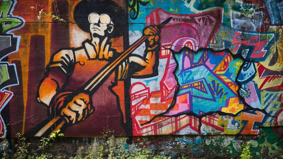 Graffiti, along with the figure of a steelworker, is painted on the side of Carrie Furnace blast furnaces in Rankin, Pennsylvania.