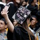 A graduating student's cap reads "Who's hiring?"