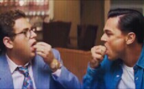 Two men in a film swallowing pills