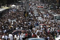 People evacuated from office buildings gather in Reforma Avenue