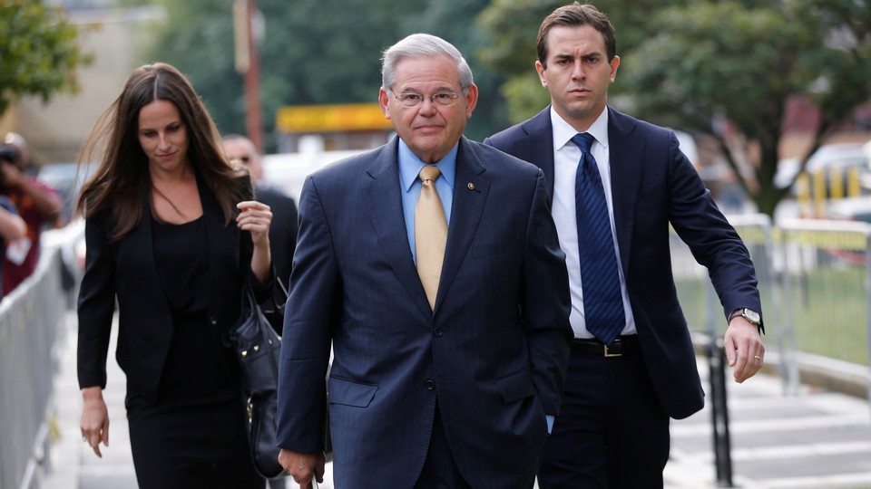 New Jersey Senator Bob Menendez pictured with two other people