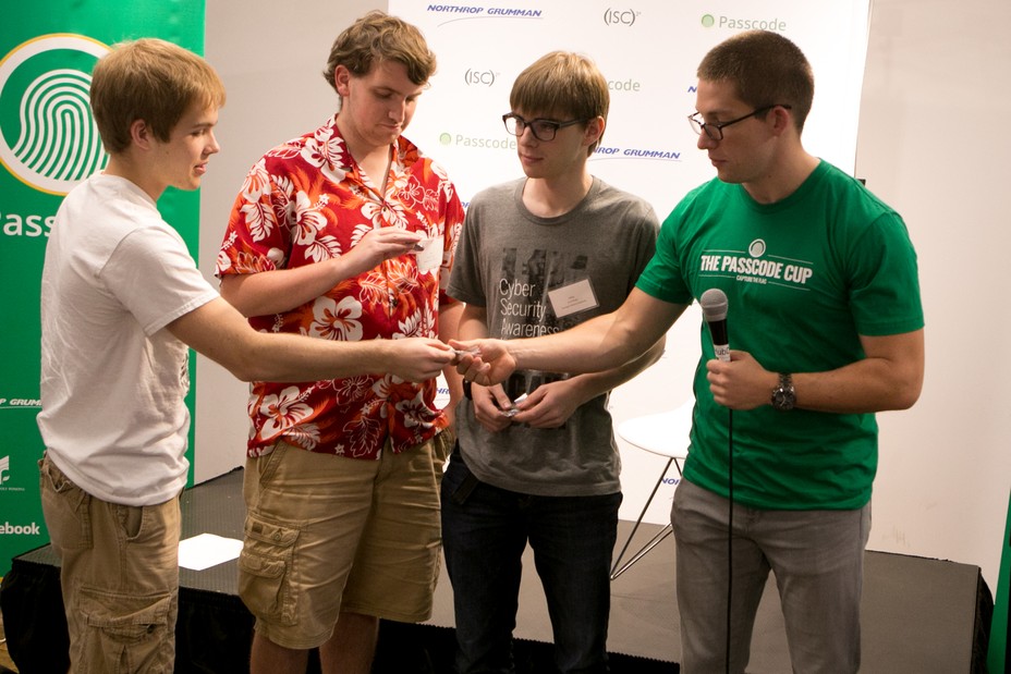 Members of the Plaid Parliament of Pwning accept a second-place award